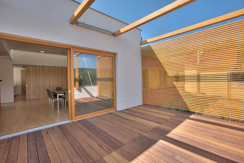 Deck with wide wood slat overhead beams for canopy
