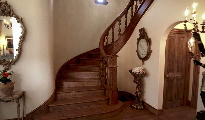 Traditional staircas and wooden clock on the wall
