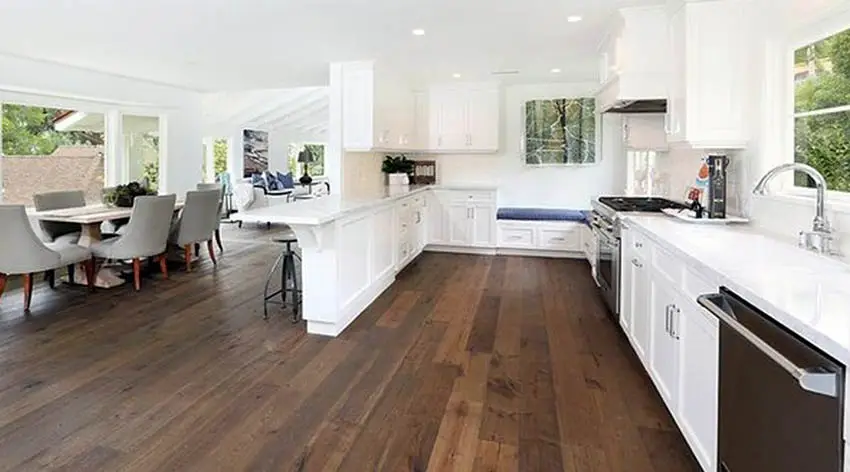 White kitchen with distressed wood flooring