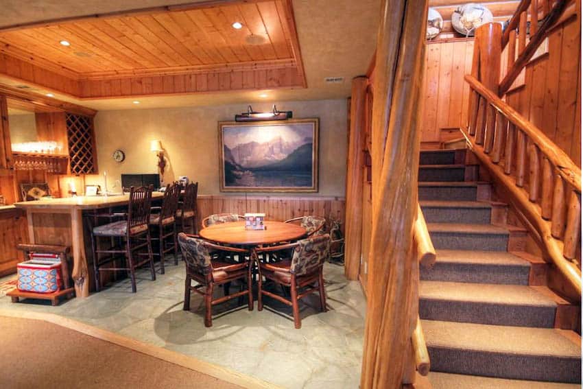 Wood basement with rustic log staircase railing