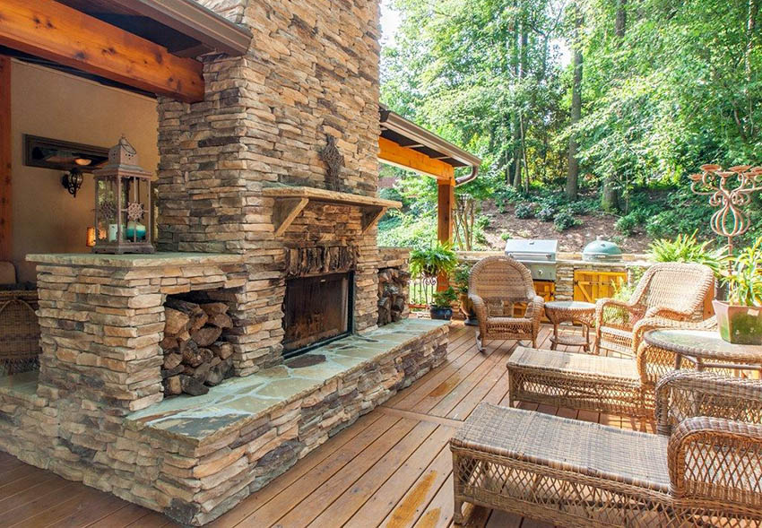 Outdoor space with stacked stone fireplace and wicker furniture