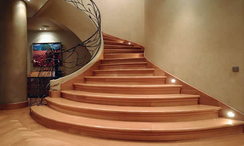 Wood staircase with metal leaf design railing