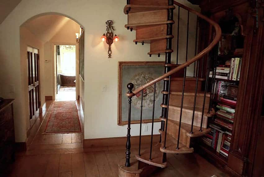 Wooden spiral staircase with wood railing and metal supports