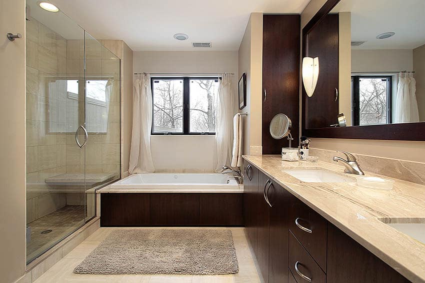 Master bathroom with travertine countertops and dark wood vanity
