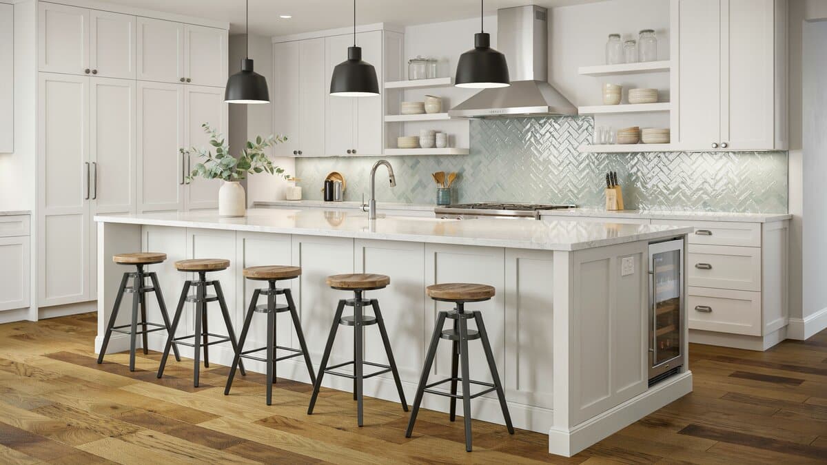 Chevron glass tile backsplash above white paneled cabinets and an island wine chiller