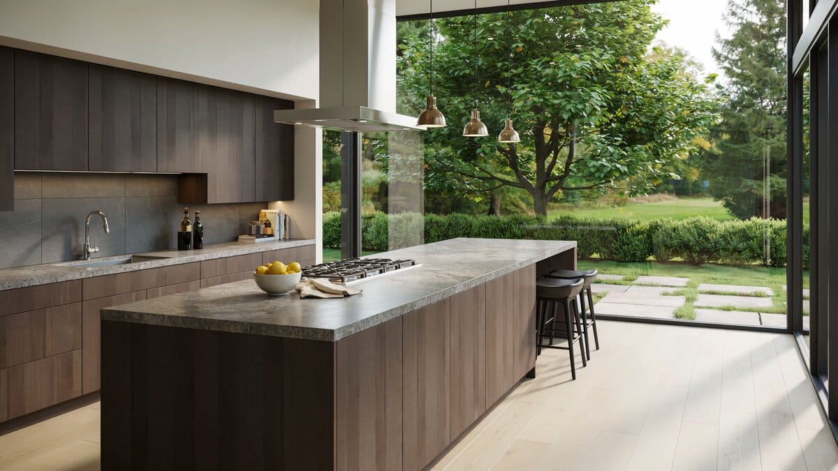 Wenge cabinets and a long island with cooktop facing wide garden windows