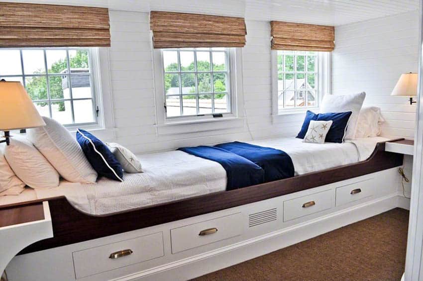 Cottage bedroom with end to end beds made from window seat
