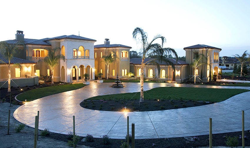 Curved driveway made with poured concrete at luxury house
