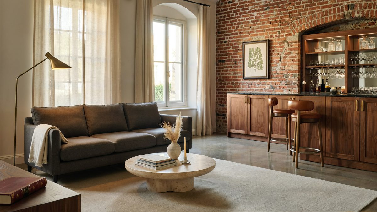 Polished concrete slab spanning a brick walled lounge with a walnut home bar