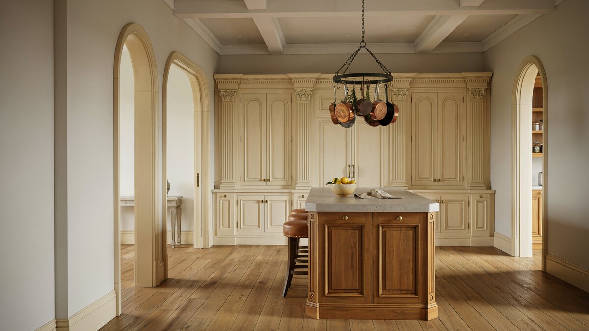 Arched openings and carved cabinetry around a walnut island with pot rack chandelier
