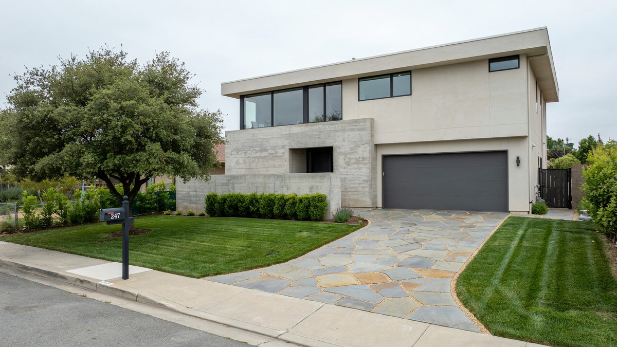 Flagstone paver driveway with mixed tan and slate blue stones at modern home