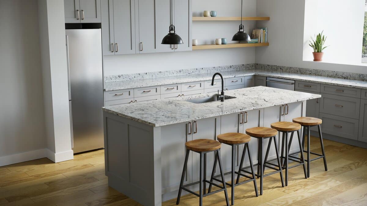 Gray cabinets and white granite with four industrial stools at the island