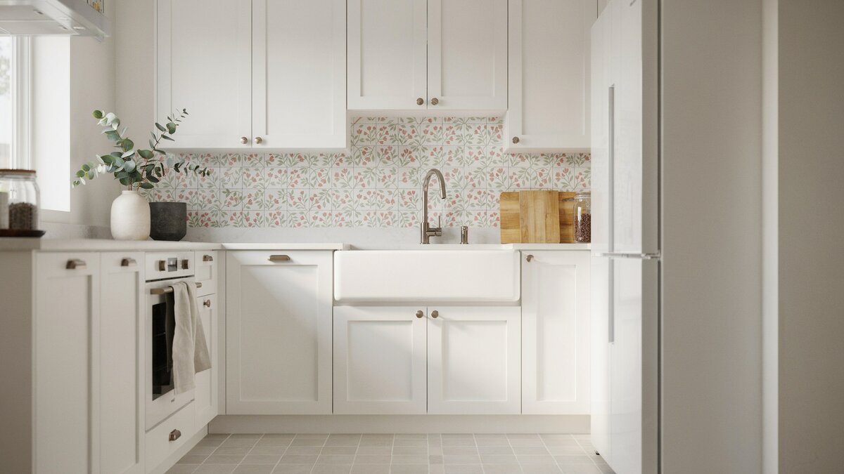 Farmhouse sink and a white refrigerator below a floral patterned tile backsplash