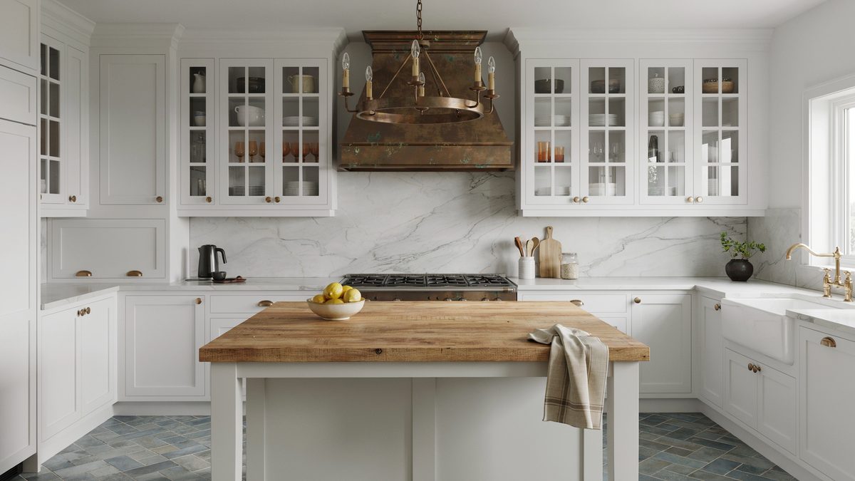 Aged copper hood above white cabinets and a pine plank island counter