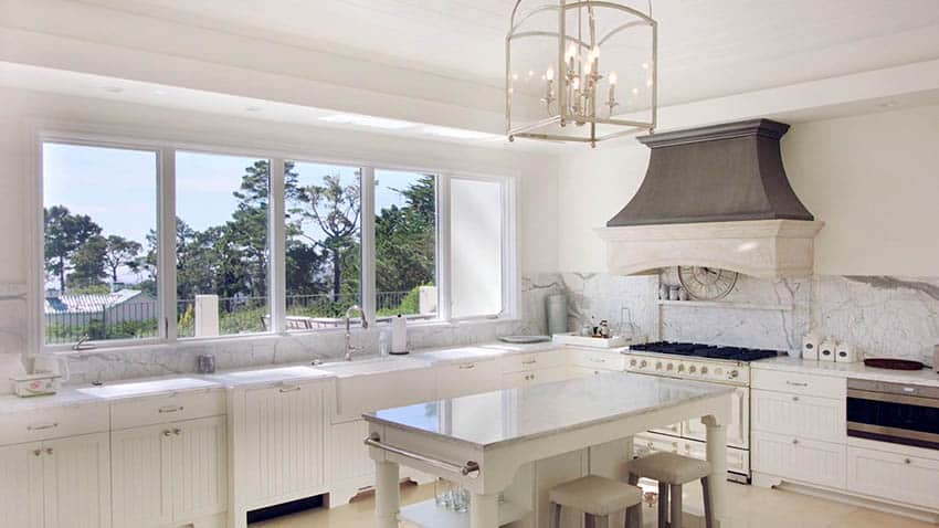 All white kitchen with beadboard cabinets and marble countertops