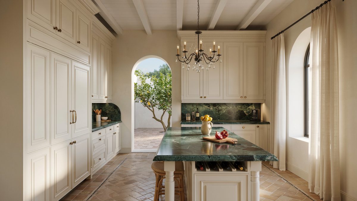 Deep green stone counters and an arched courtyard door in a Mediterranean kitchen