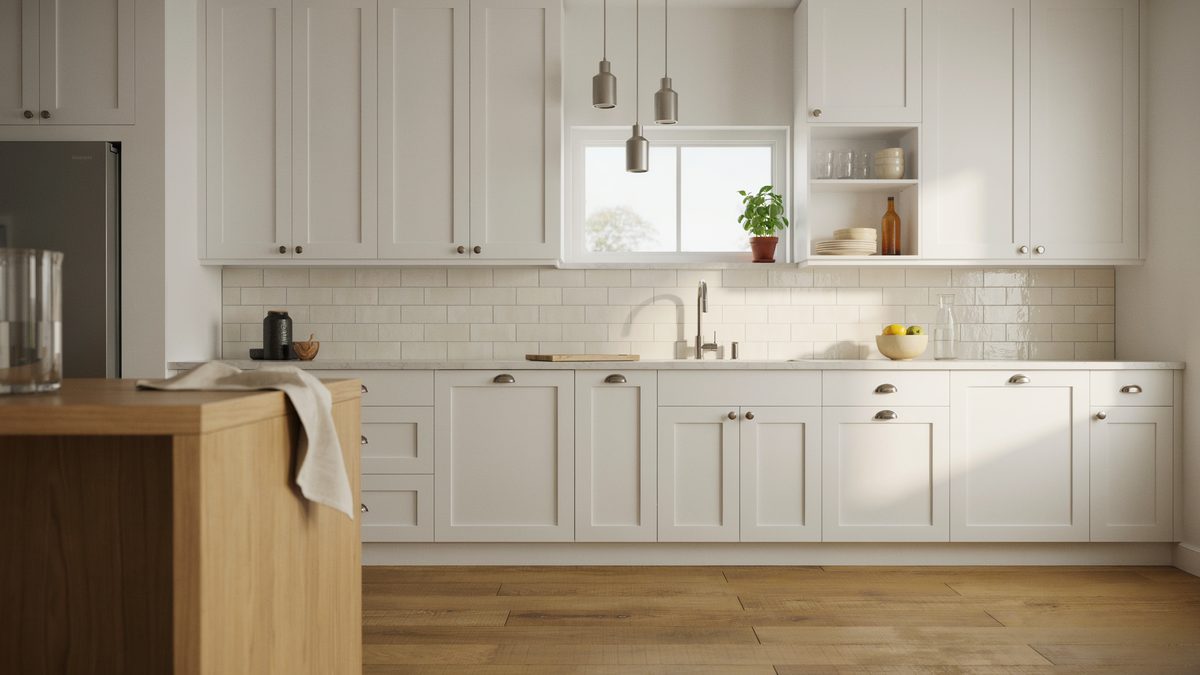 Small metal pendants light a wood topped island against white subway tile