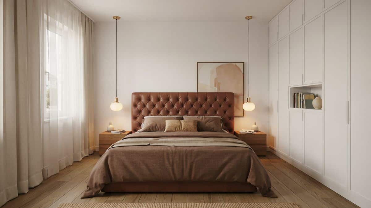 Contemporary bedroom in brown palette with tufted leather headboard and white built in cabinets