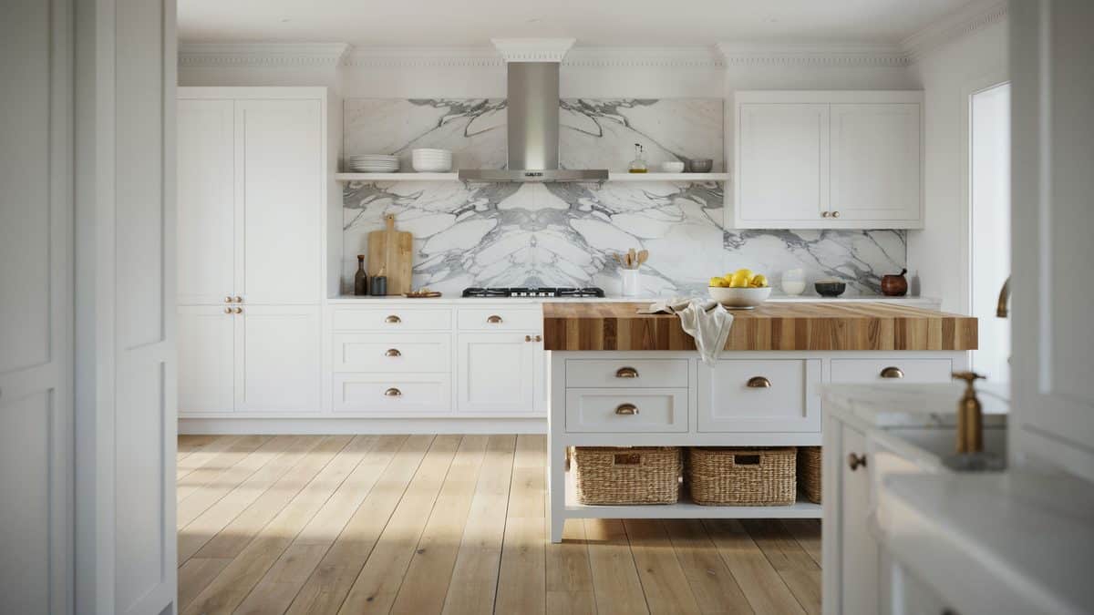 Butcher block island and a full marble slab backsplash behind the range