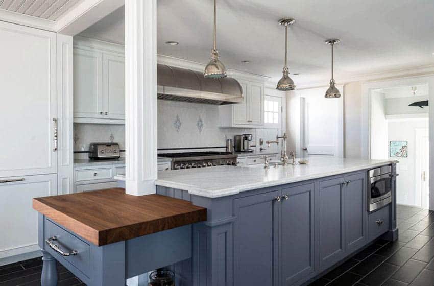 Traditional kitchen with white cabinets blue island with support beam