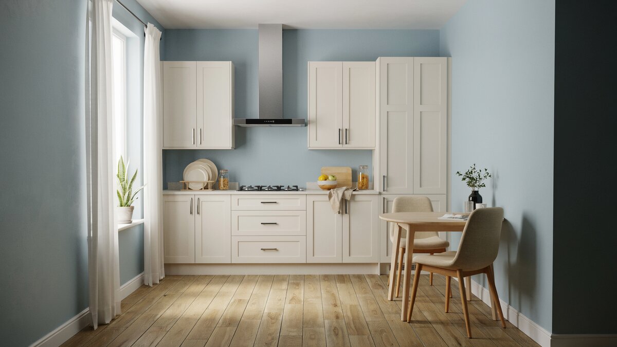 Light blue walls with off white cabinets, beige dining chairs and wood board flooring