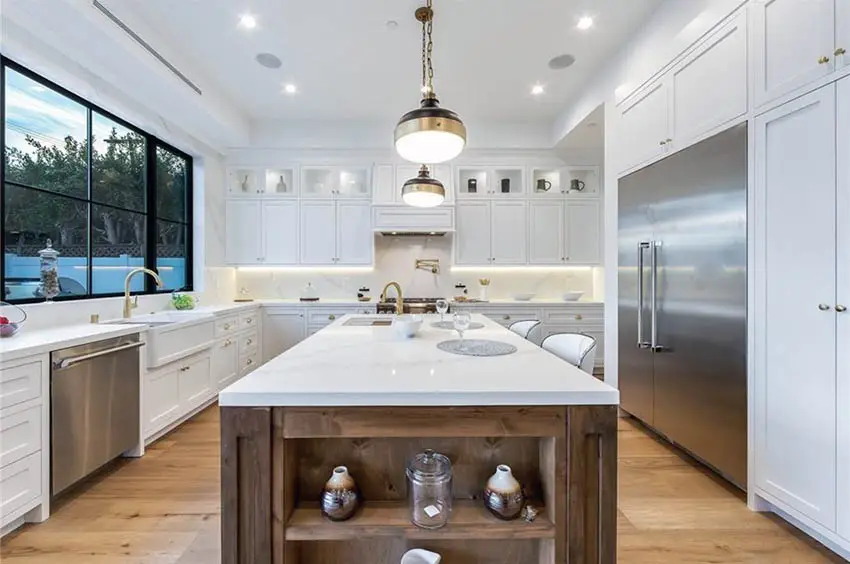 Contemporary kitchen with wood island marble countertops and white cabinets