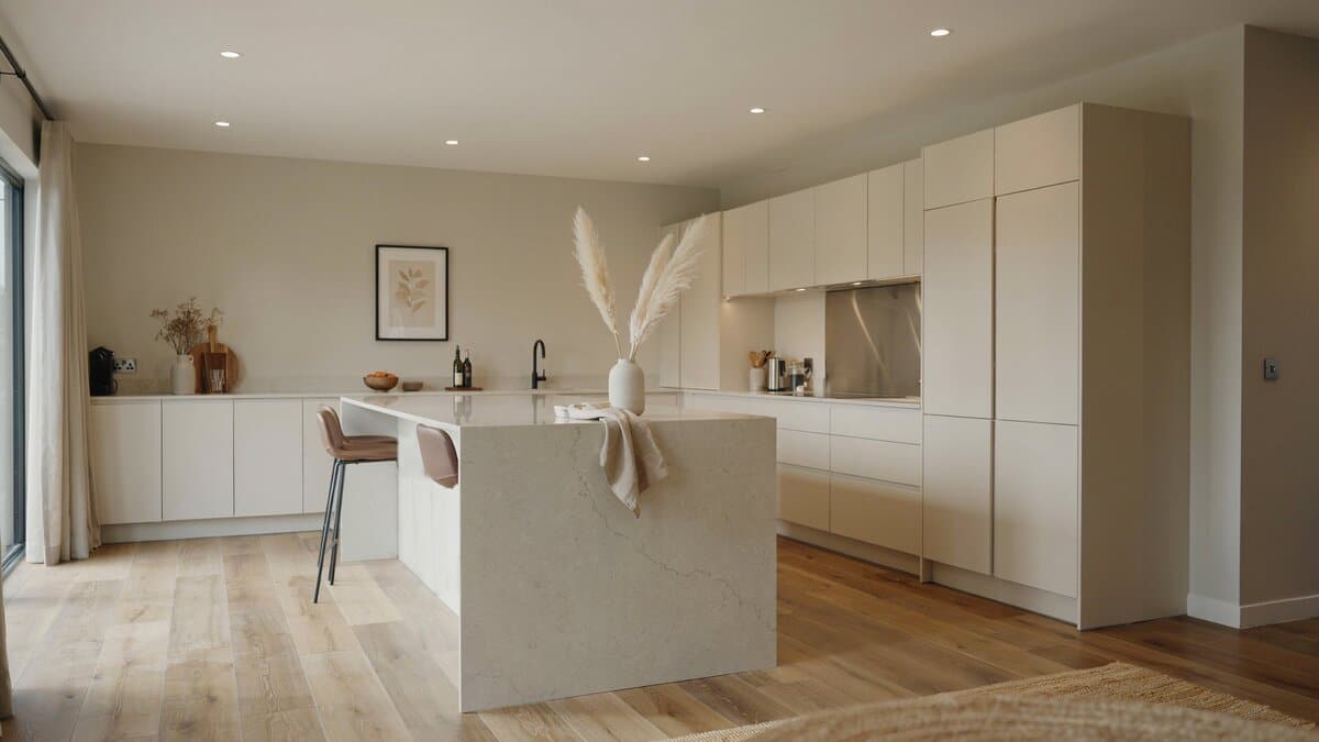 Greige walls and recessed ceiling lights above sleek European cabinets and light wood floors