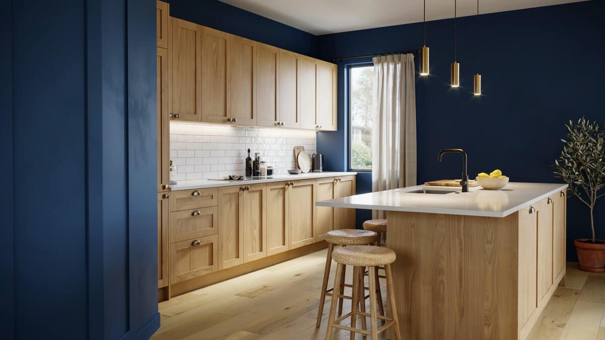 Navy blue walls behind light wood cabinets and a white solid surface island