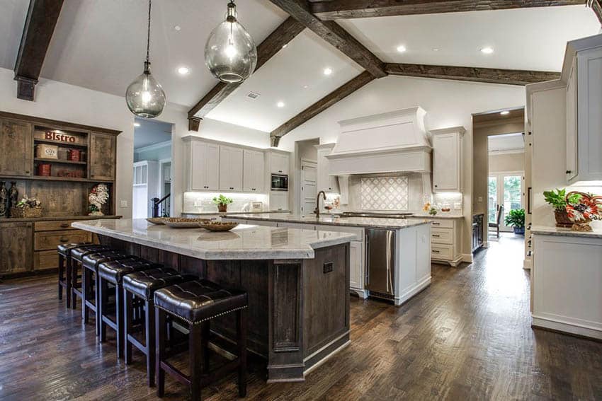 Rustic contemporary kitchen with double islands wood floors beams and leather bar stools
