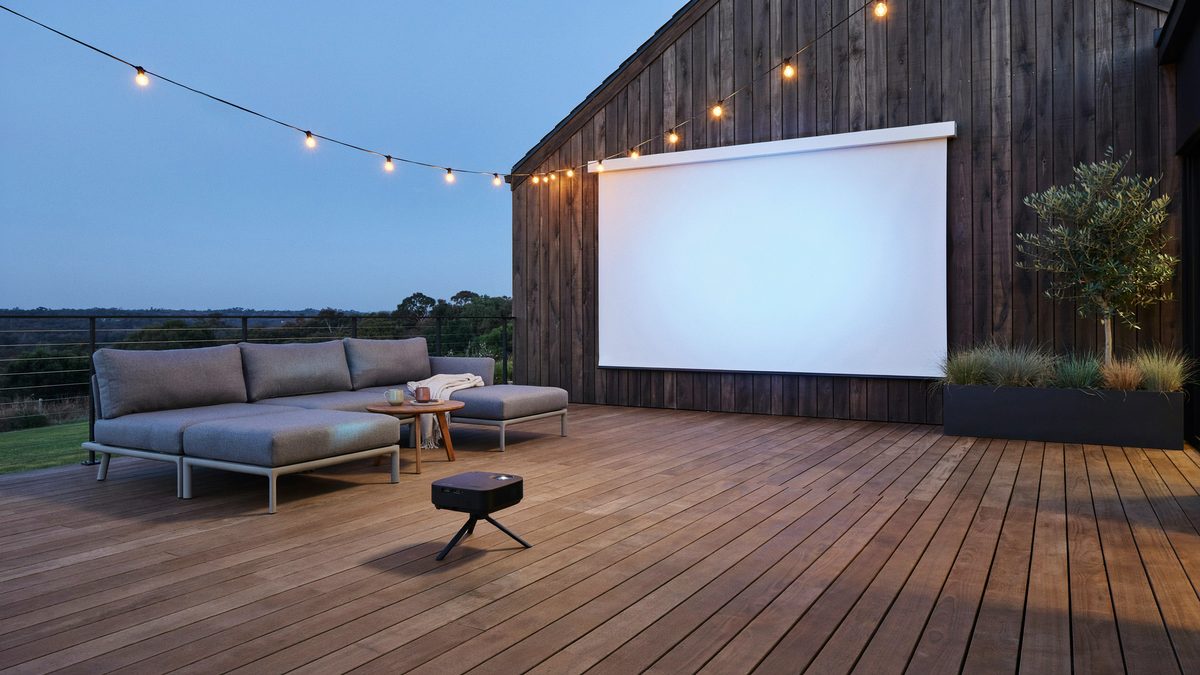 Contemporary deck with a wall mounted projector screen and two gray couches