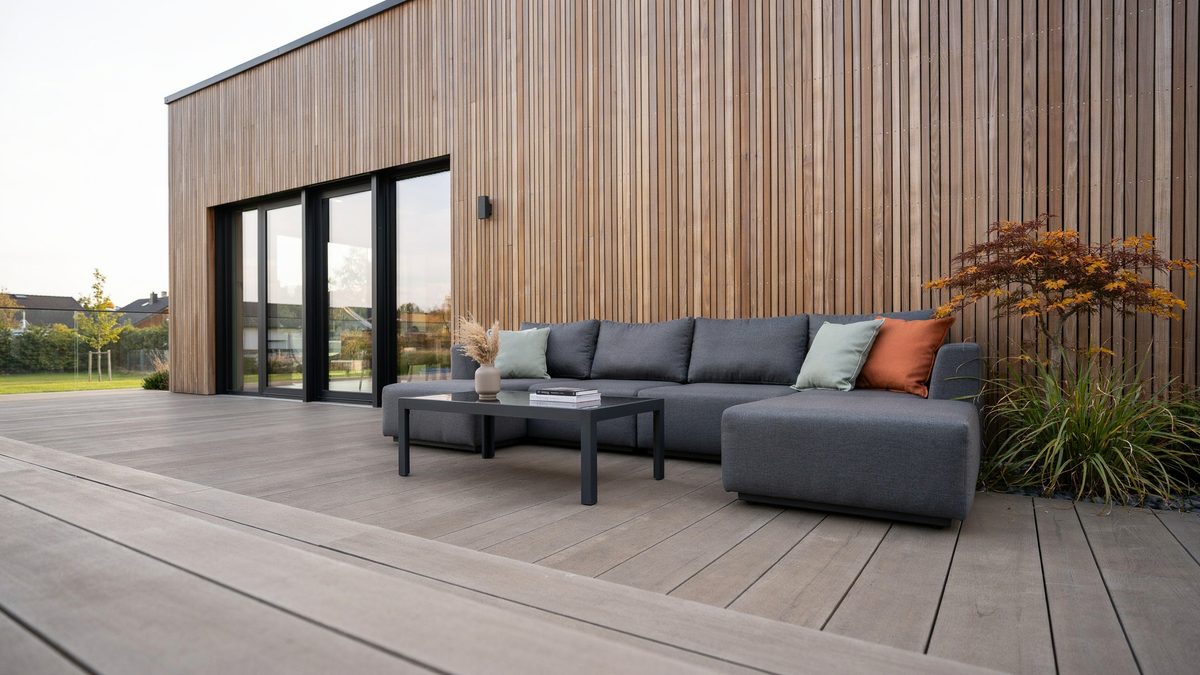Composite deck with a gray outdoor sectional and low slung coffee table