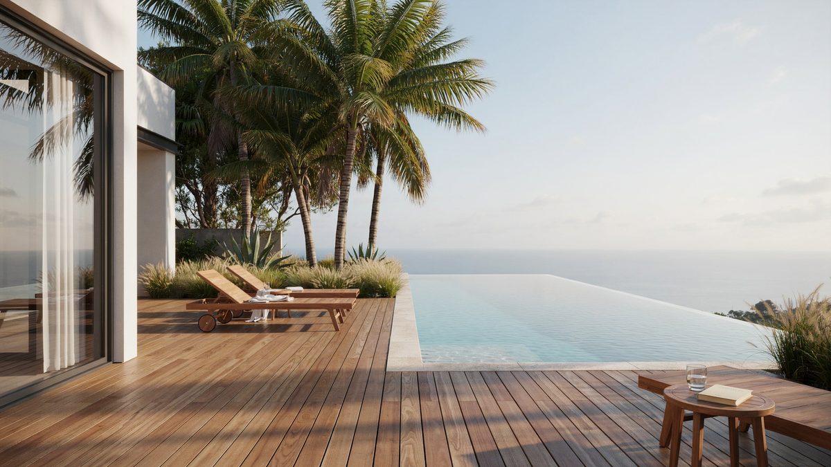 Infinity edge rectangular pool with a wood deck and palm trees behind