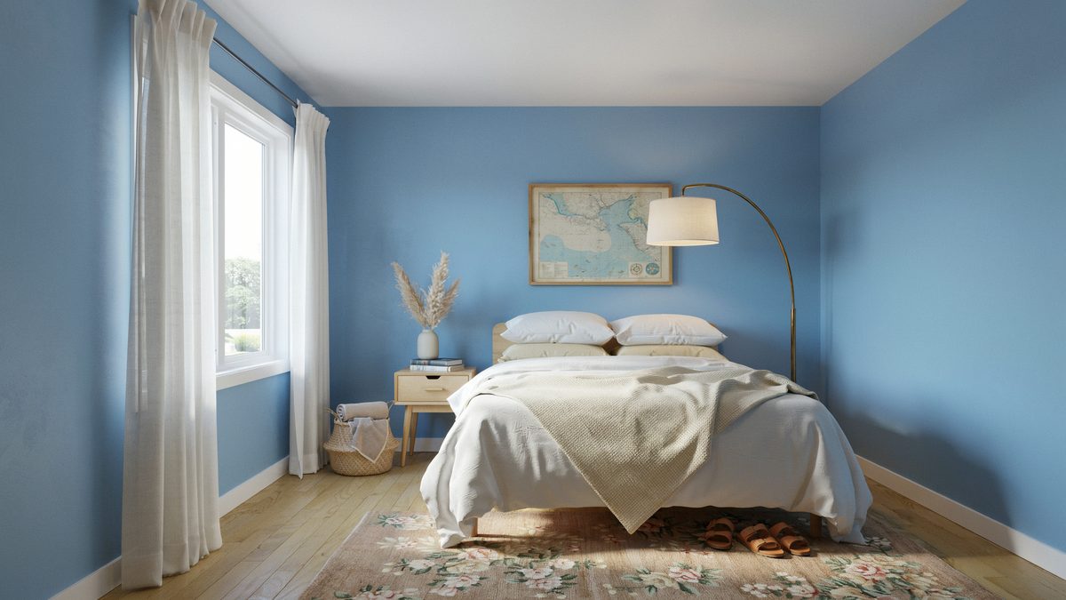 Soft blue walls with an arched lamp, white bedding and light wood floor