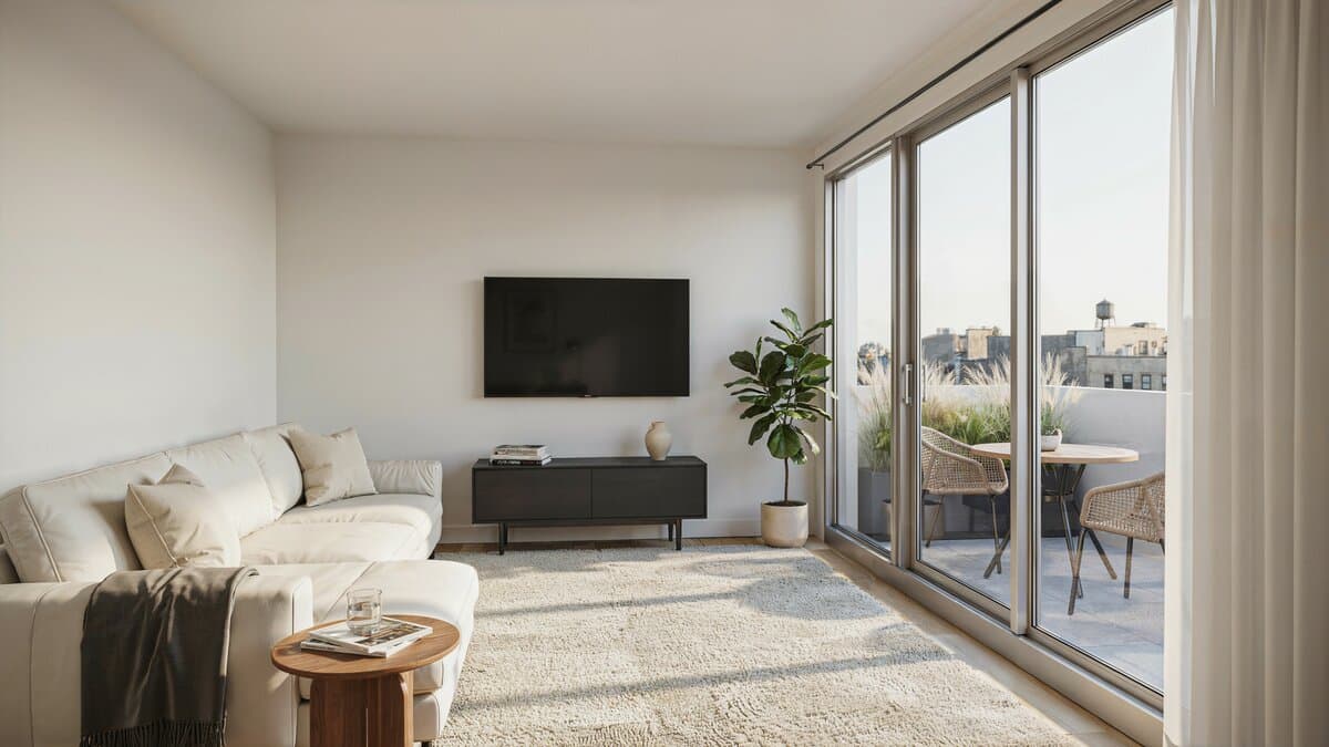Clean white living room with black entertainment center and large sliding doors to outdoor rooftop patio