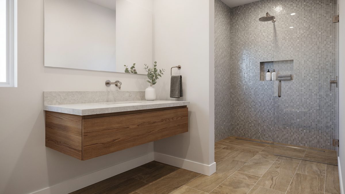Wood floating vanity with white granite counter facing a gray mosaic tile shower