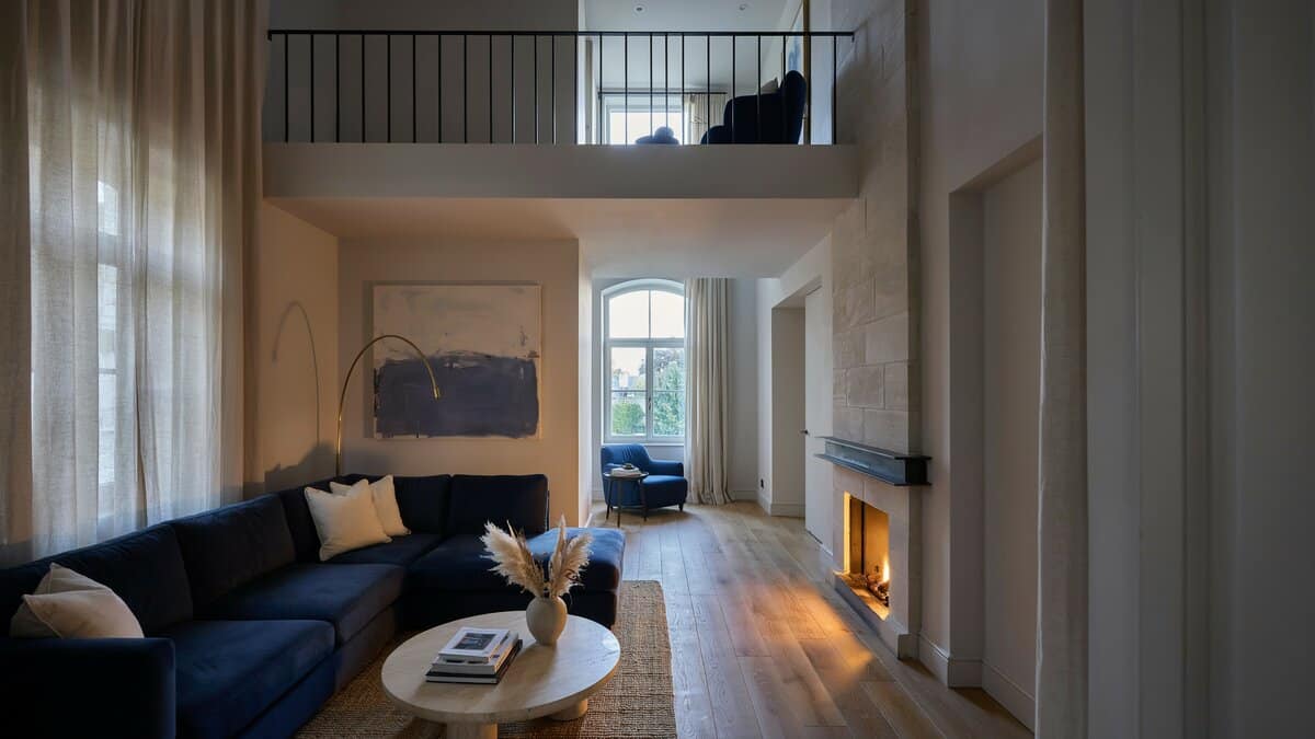 Contemporary living room with blue color theme, high ceilings and fireplace