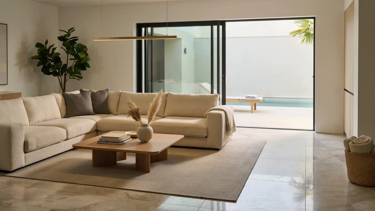 Contemporary living room with large sectional sofa and sliding glass doors to pool patio