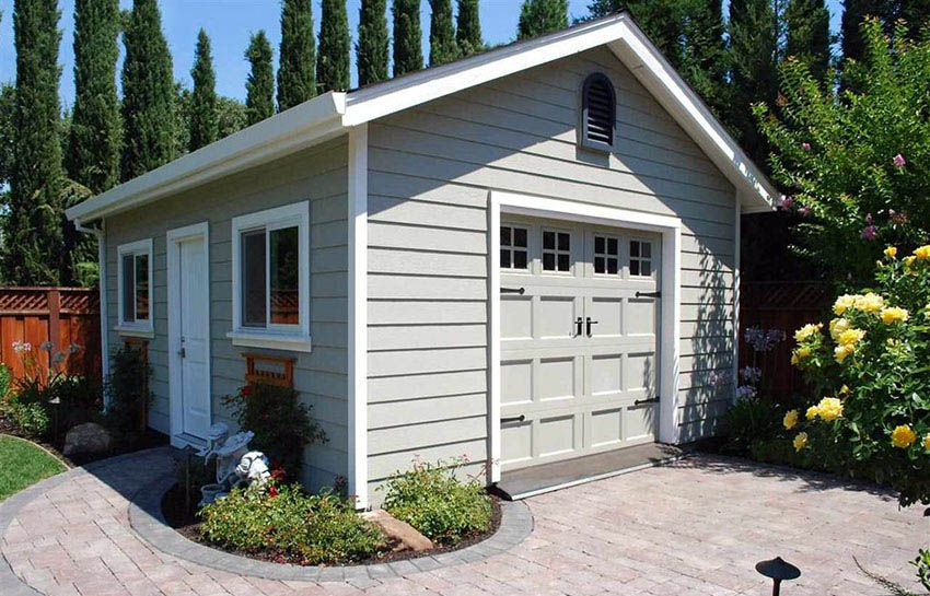 Custom shed with double doors and white siding