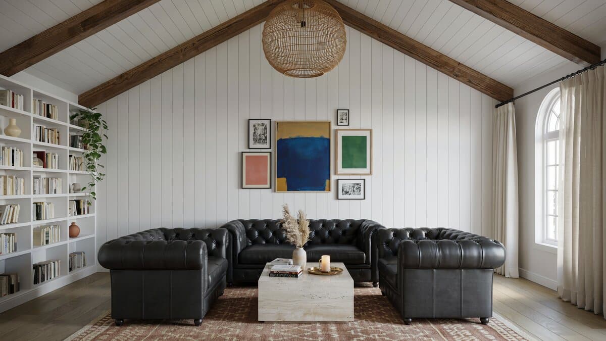High end living room with exposed beams white paneled walls and artwork