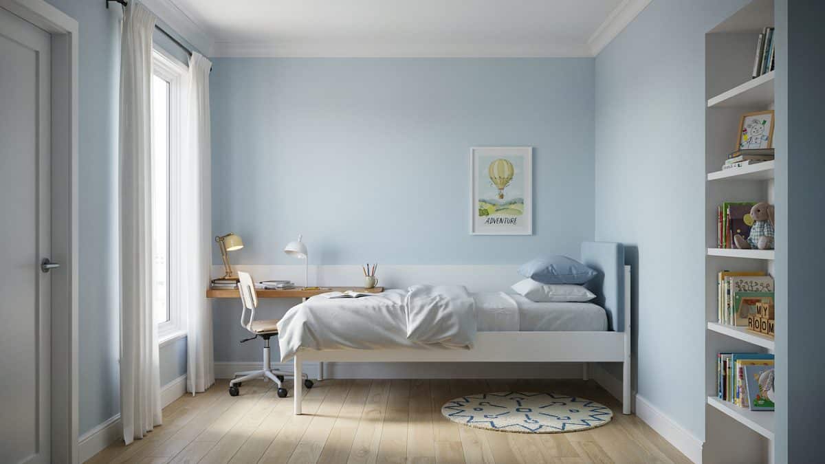 Light blue kids room with a wall mounted desk and white built in shelves