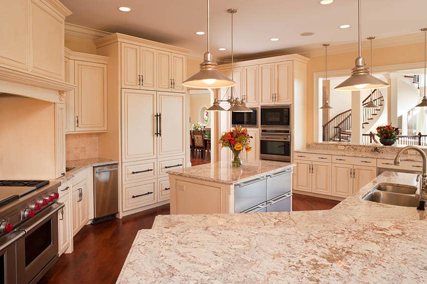 Antique white cabinet finish, pendant lights and bronze hardware