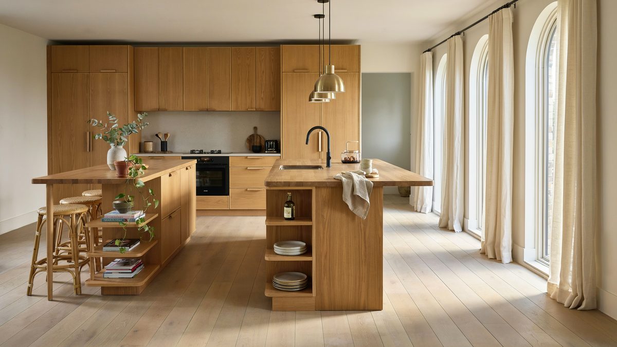 Two oak islands with open shelf ends in a warm timber kitchen