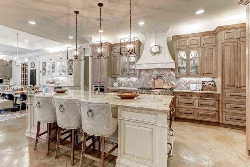 Kitchen with antique white island with wood cabinets and beige granite countertops