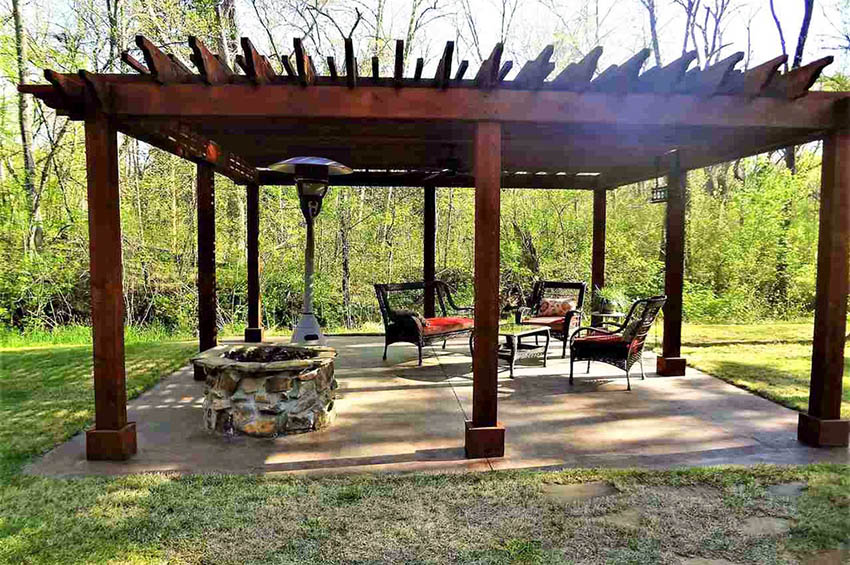 Large pergola with rock fire pit and concrete patio