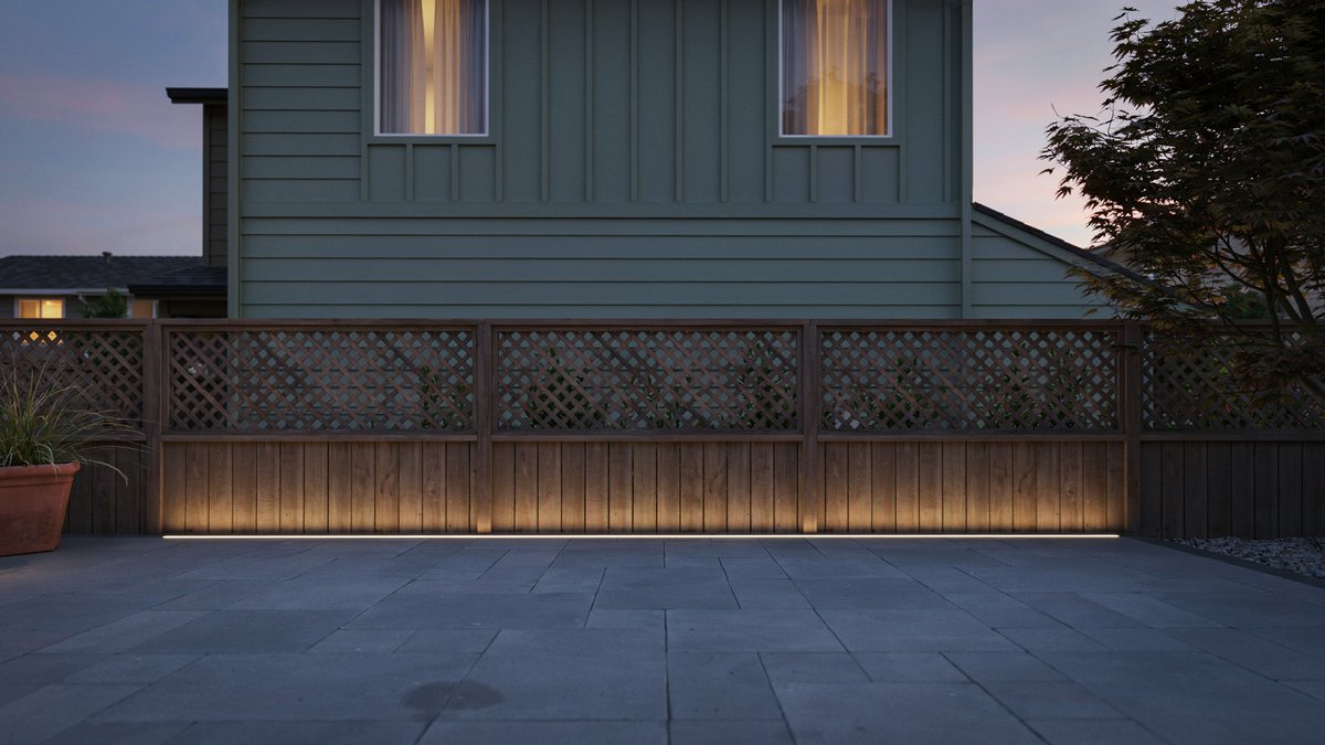 Lattice topped fence glowing with warm strip lighting at dusk