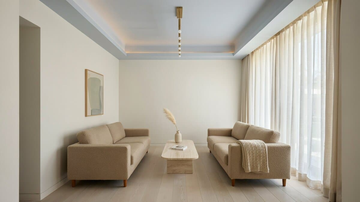 Lovely living room with blue box ceiling and wood flooring