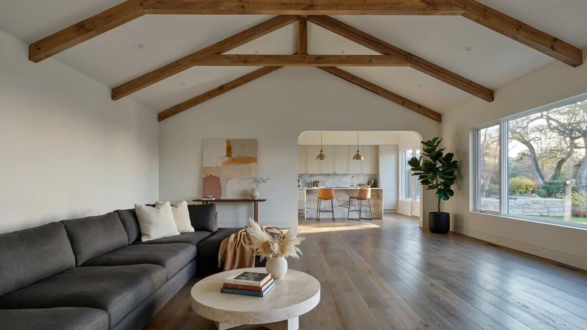 Luxury living room with vaulted ceiling dark wood floors and open to kitchen