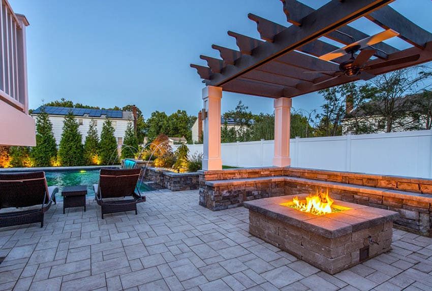 Modern backyard with pergola fire pit and stone bench