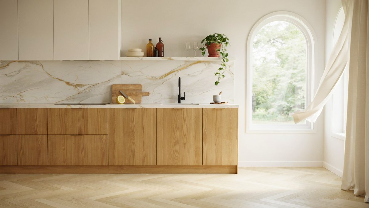 Warm oak slab cabinetry below a gold veined marble counter and backsplash