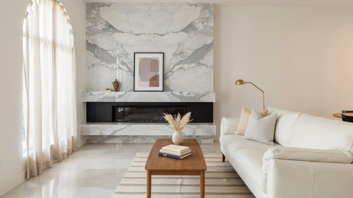 Modern living room with white marble panel fireplace and white porcelain tile flooring